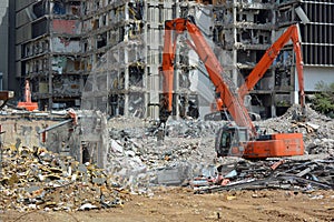 Orange Backhoes Demolish Building