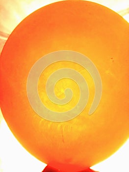 Orange ballon in the sunlight background
