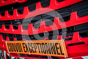 Orange banner in the front of the truck with text Convoi Exceptionnel