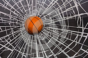 Orange basketball ball in a broken window