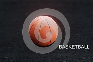 Orange basketball on black background, asphalt court, blurred background, 3d rendering