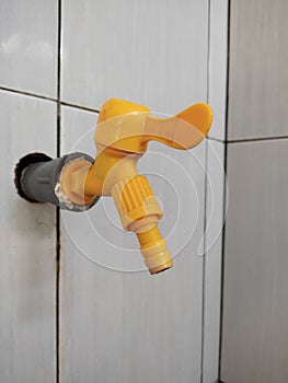 orange bathroom faucet, made of plastic.