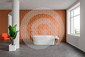 Orange bathroom interior with tub