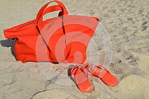 Orange beach bag and flip flops