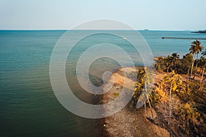 Orange beach and coconut trees in the evening