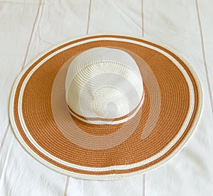 Orange beach hat on bed