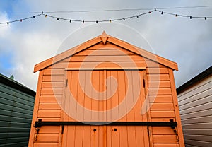 An orange beach hut in Felixstowe, UK.