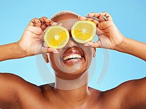 Orange, beauty and smile with a model black woman in studio on a blue background for a facial. Food, skincare and