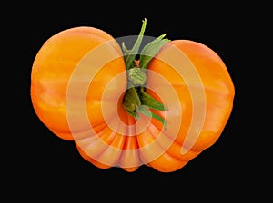 Orange beefsteak tomato with green stem