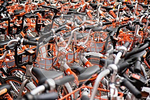 Orange Bicycle Amidst Crowded Scene with Selective Focus