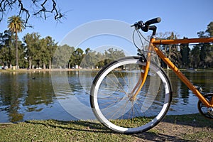 Orange bicycle next to a lake in Buenos Aires, Argentina