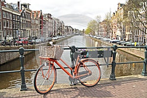 Orange bike in Amsterdam city in the Netherlands