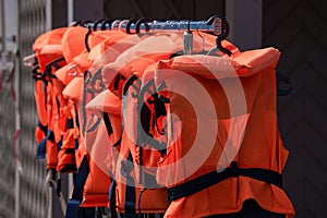 Orange and black lifejackets in a row