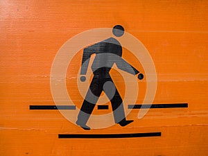 The orange-black pedestrian symbol