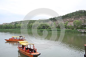 Mountains, lakes, and boats photo