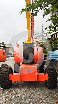 Orange boom Lift 24 meters articulate front view