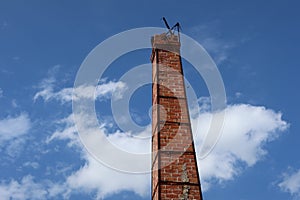 Orange brick smokestack crematorium crematorium in Thai temple, normal sky background, can be called funeral concept.