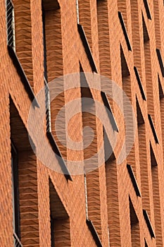 Orange brick wall with windows of modern building