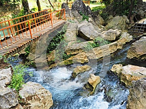 Orange bridge to cross a beautiful and colorful little river in Vang Vieng, Laos