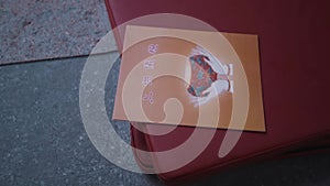 Orange Buddhist laying down on the mattress and being held in the monk's hands for praying