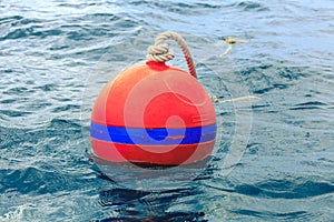 Orange buoy on blue sea