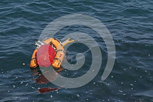 Orange buoy-boat with fishing tackle