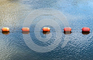 Orange buoys floating on the waterway