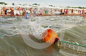 Orange buoys on the sea beach