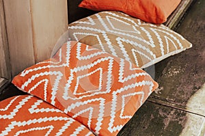 Orange cafe pillows on the desk closeup. Cafe exterior