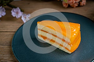 Orange cake on black plate