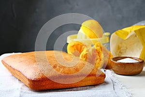 Orange cake or bread with ingreients on table photo