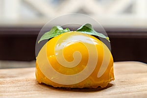 Orange cake placed on wooden board