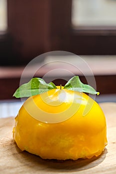 Orange cake placed on wooden board