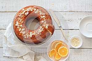 Orange cake served on a white wooden table view from above