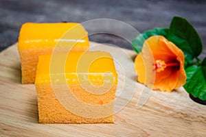 Orange cake on wooden background.