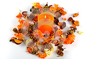 Orange candle and dry petals