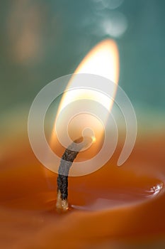 Orange candle light with a turquoise background