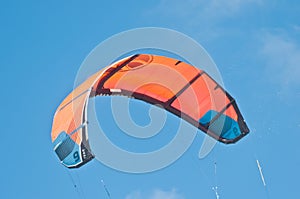 Orange canopy, filled with wind power, to propel a kite board