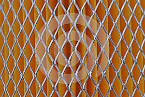 Orange car filter background with iron grille close-up