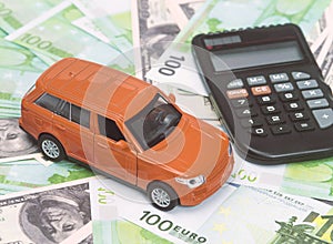 Orange car and money, euro and dollars