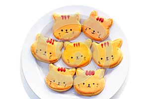 Orange cat royal icing cookies on white plate