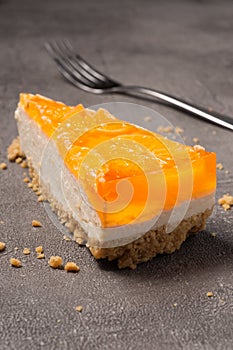 orange cheesecake on a gray background. close-up