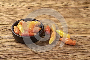 Orange cheiro scent/smell pepper on a bowl over wooden table photo