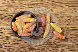Orange cheiro scent/smell pepper on a bowl over wooden table photo