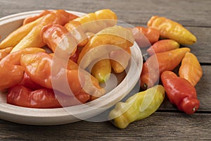 Orange cheiro scent/smell pepper on a plate over wooden table
