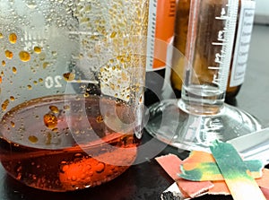 Orange chemical reaction inside a glass beaker