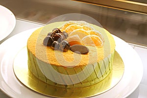 Orange chiffon cake on white dish.