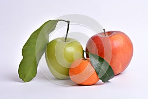 Orange clementine and apples with leaves