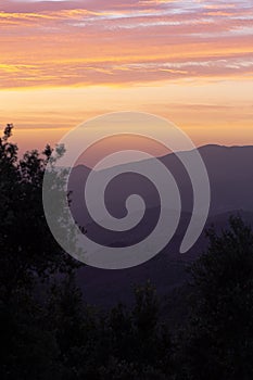 Orange clouds on a mountain landscape sunset sky