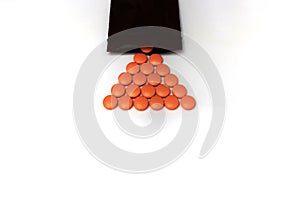 Orange coated round drug tablets on drugstore and bottle in communicated worldwide distribution business medical pharmaceutical